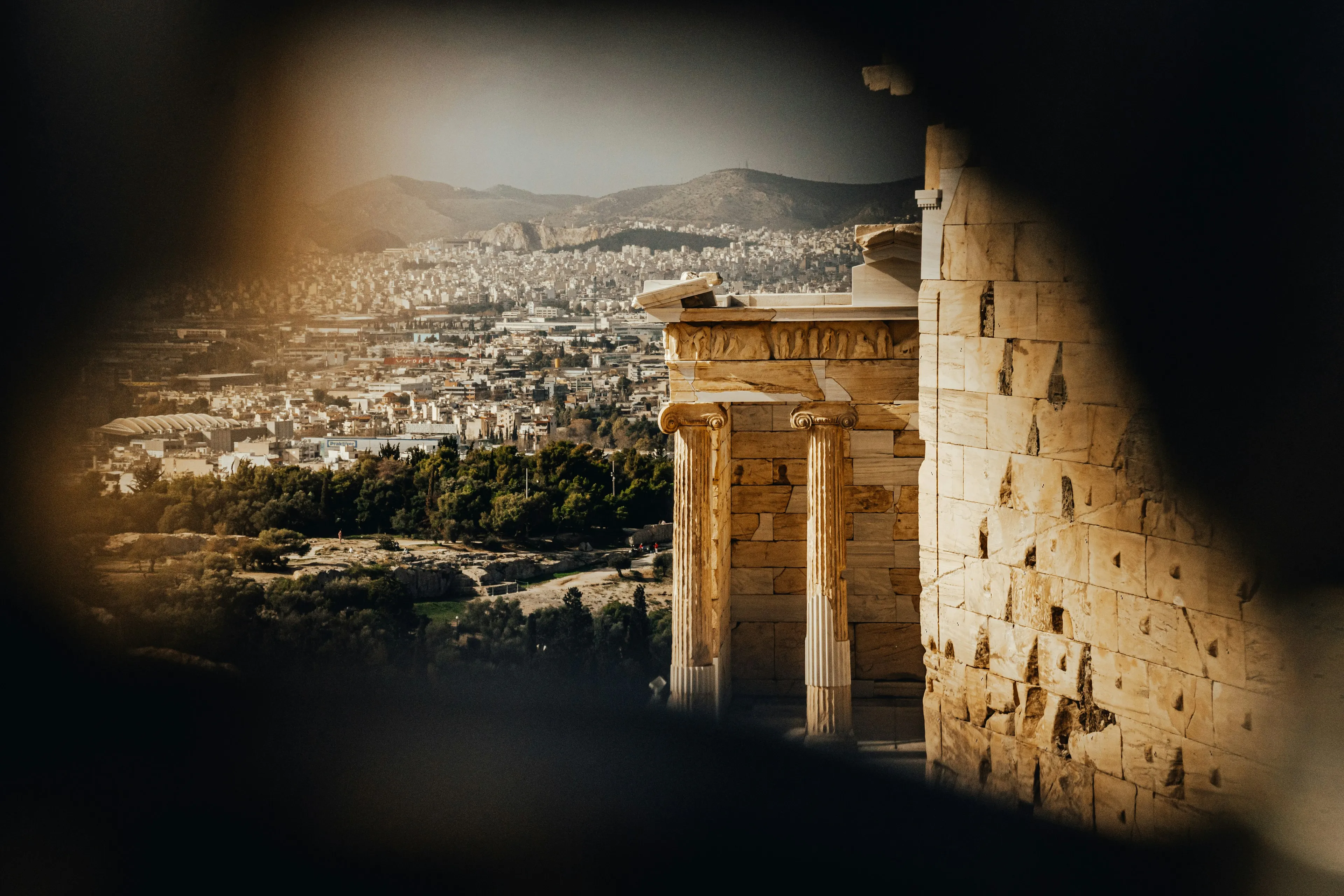 Athenian skyline and ancient Acropolis columns at golden hour, hero image for The Halo Collection contact page.