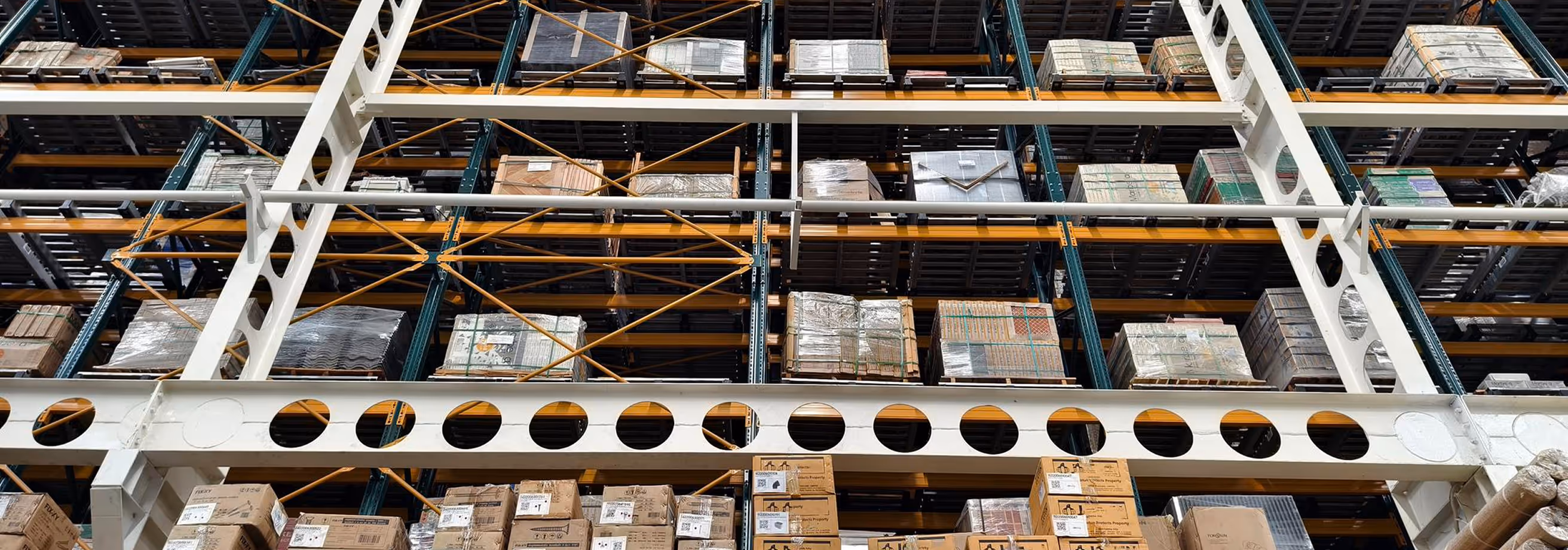 Warehouse storage racks filled with stacked pallets and boxes
