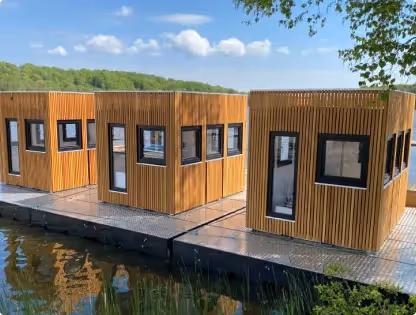 Floating decontamination trailer with two bathroom units featuring multiple windows and separate entrances