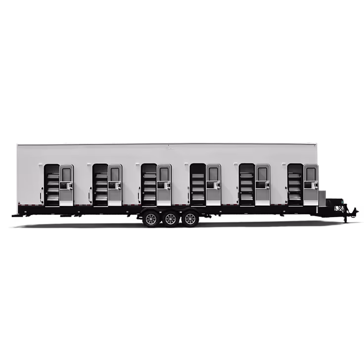 Long white trailer with six separate entry doors, each with steps and windows.