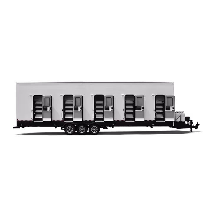 White trailer with four separate entrance doors and steps on a triple-axle chassis.