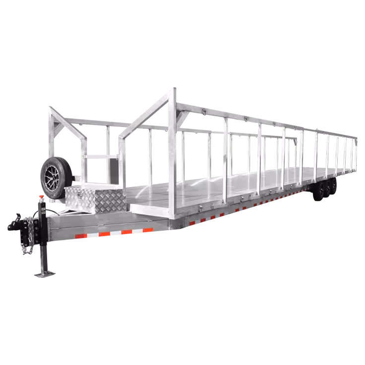 Long aluminum flatbed trailer with side rails and a mounted spare tire at the front.