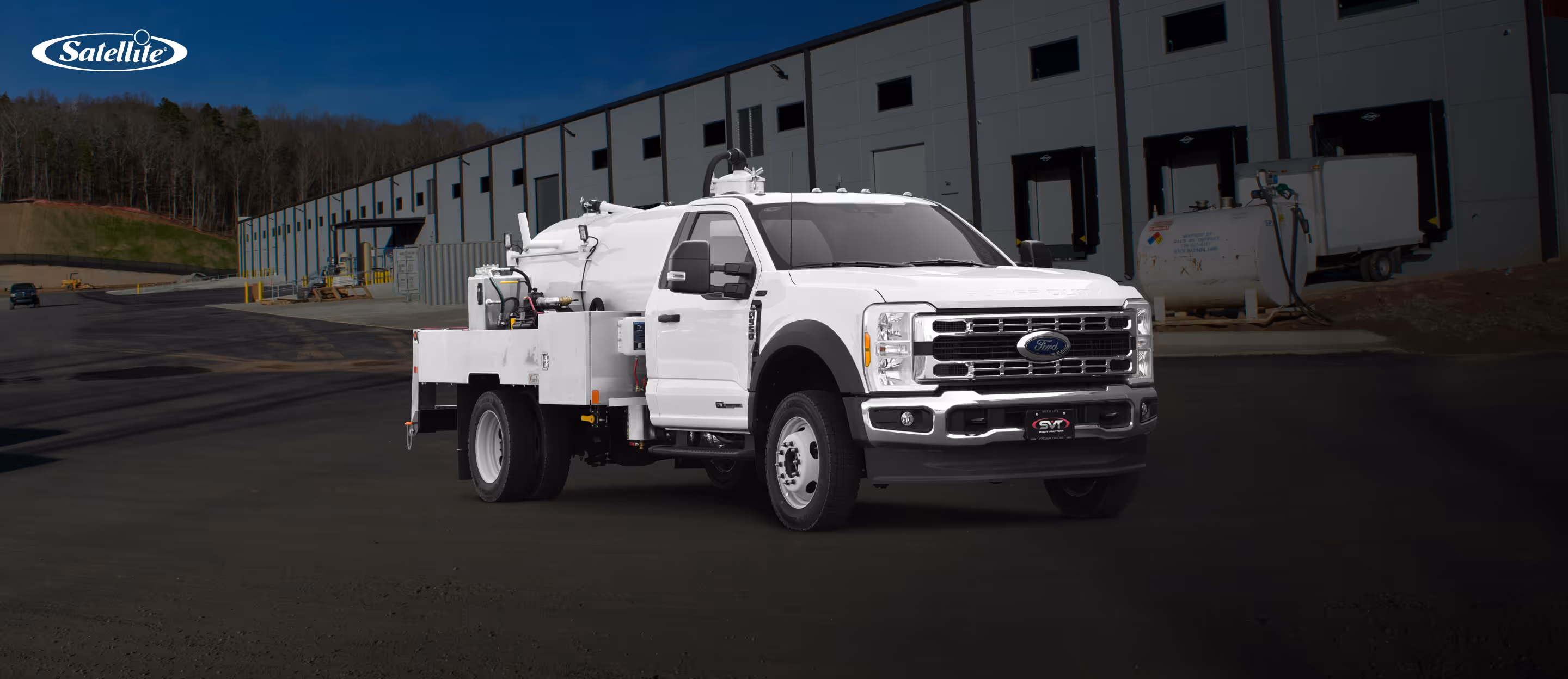 Portable sanitation vacuum truck built by Satellite Industries positioned outside Satellite Industries state-of-the-art manufacturing facility, representing advanced engineering, durable construction, and reliable fleet performance.