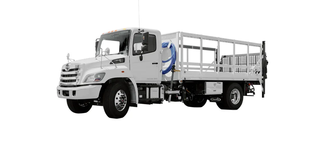 White flatbed truck with a cab, featuring a flat cargo area and rear railing.