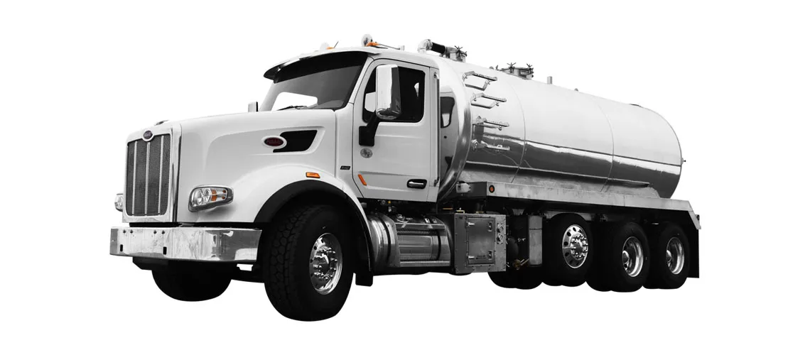 White tanker truck with three axles and a polished aluminum tank, equipped for hauling liquids.
