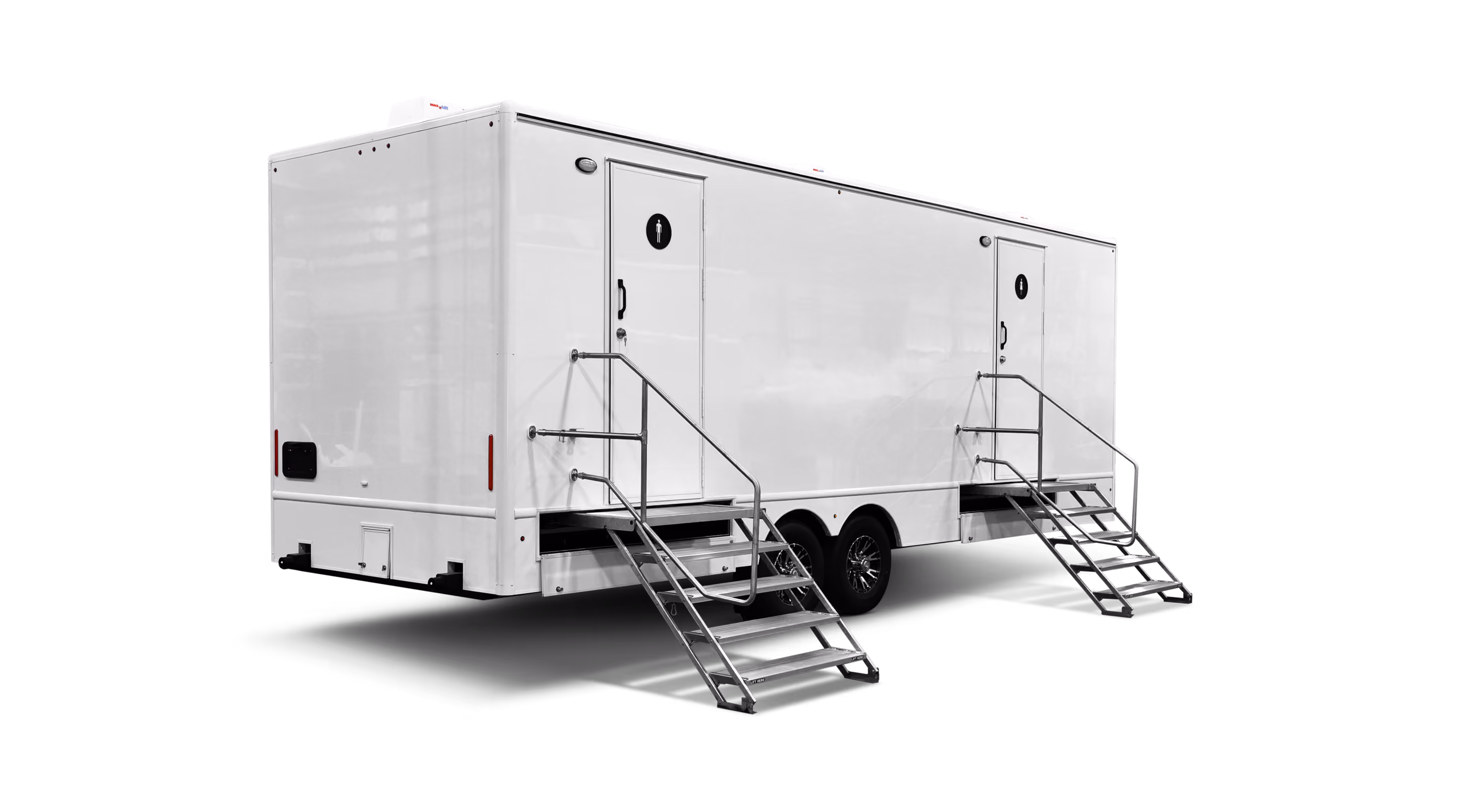 A large, white mobile restroom trailer with two external stairs and doors at each end.