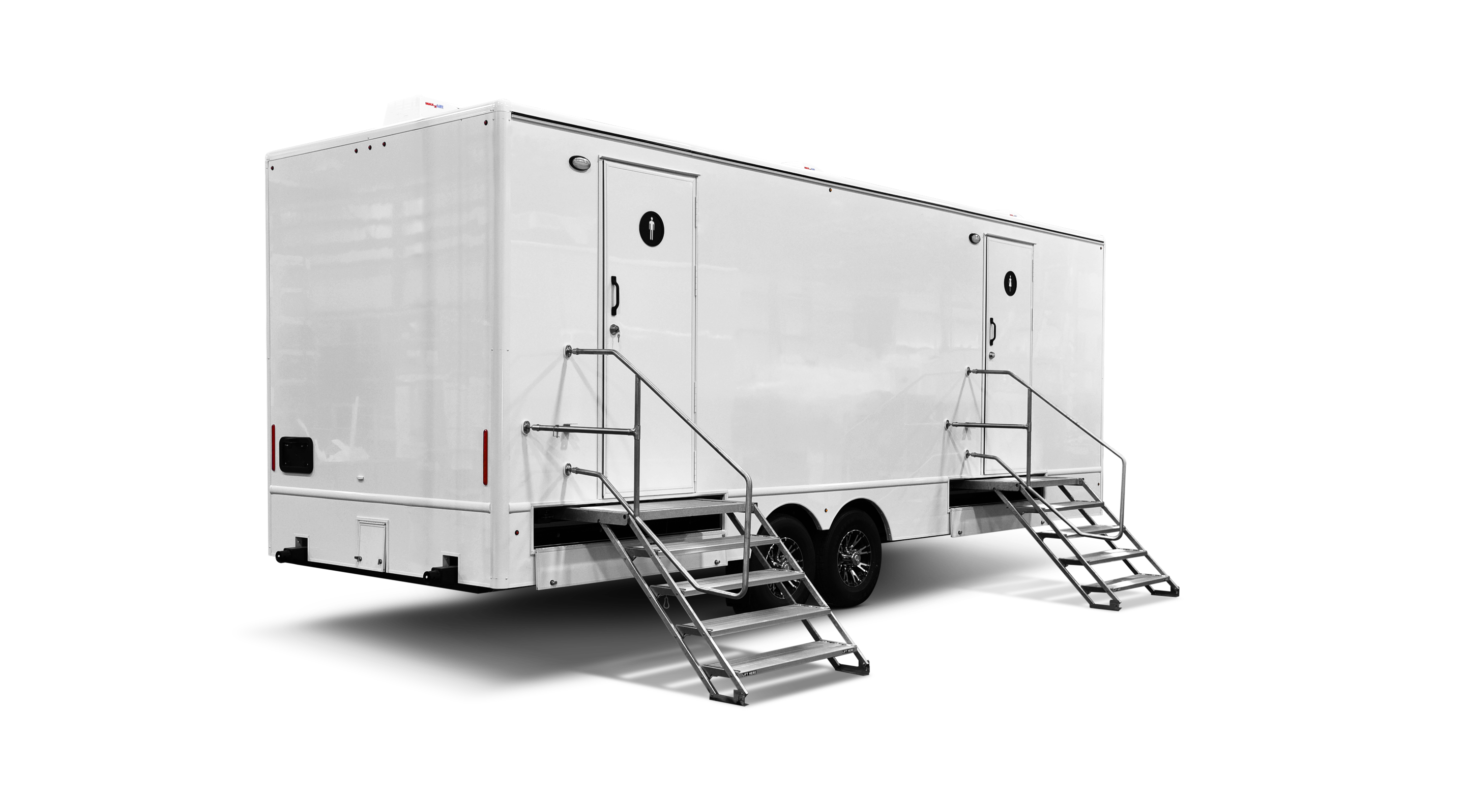 A large, white mobile restroom trailer with two external stairs and doors at each end.