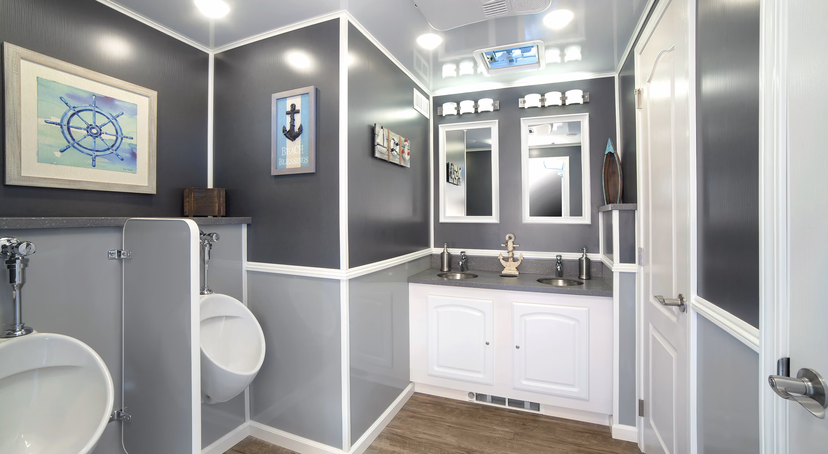 Men's restroom featuring dual sinks, urinals, and modern decor in gray and white tones.