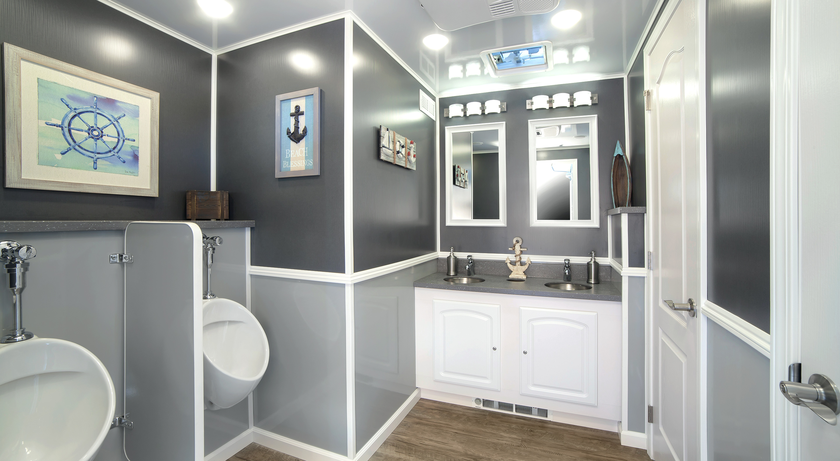 Men's restroom featuring dual sinks, urinals, and modern decor in gray and white tones.