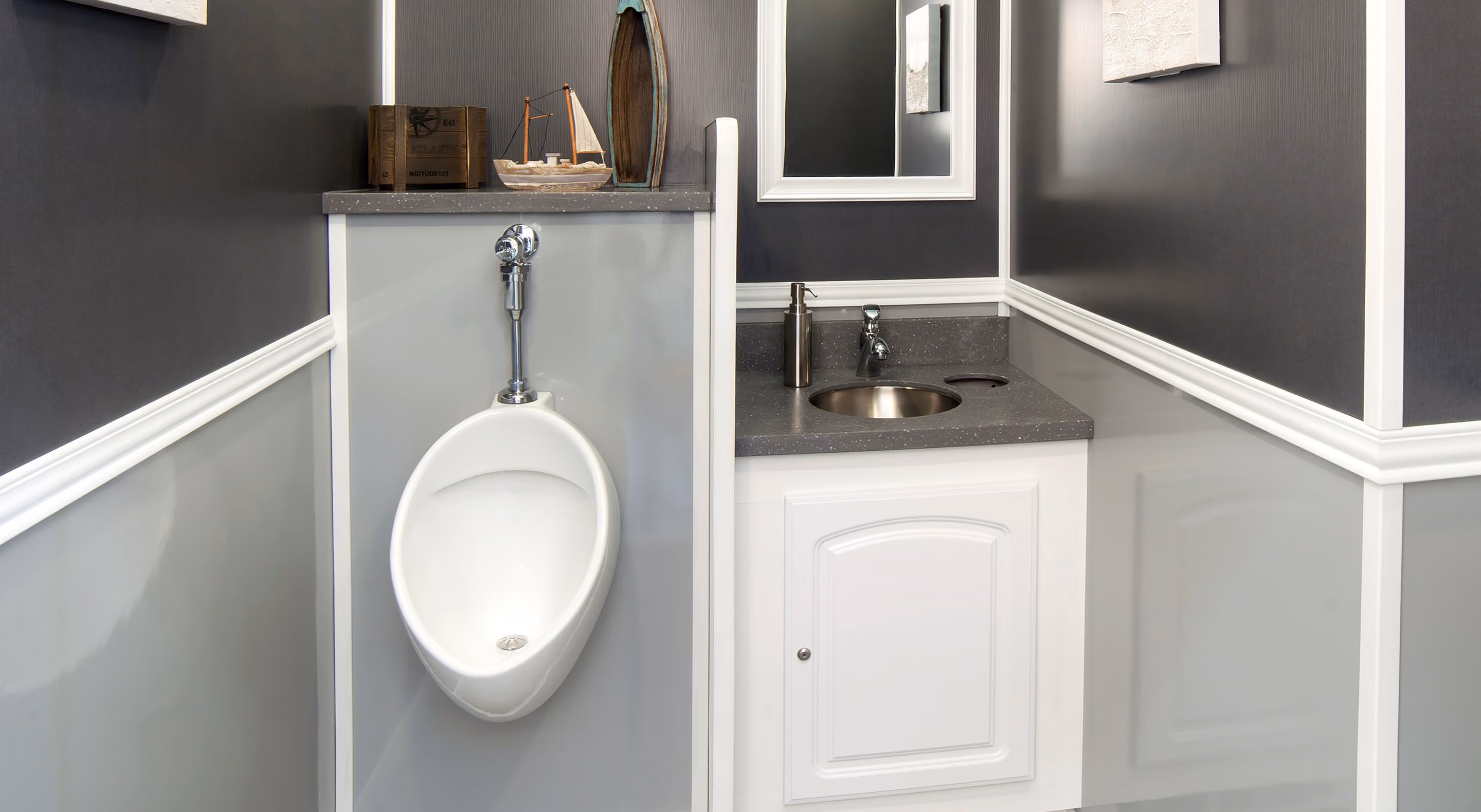 Modern men's restroom featuring a urinal, sink, and sleek gray and white walls.
