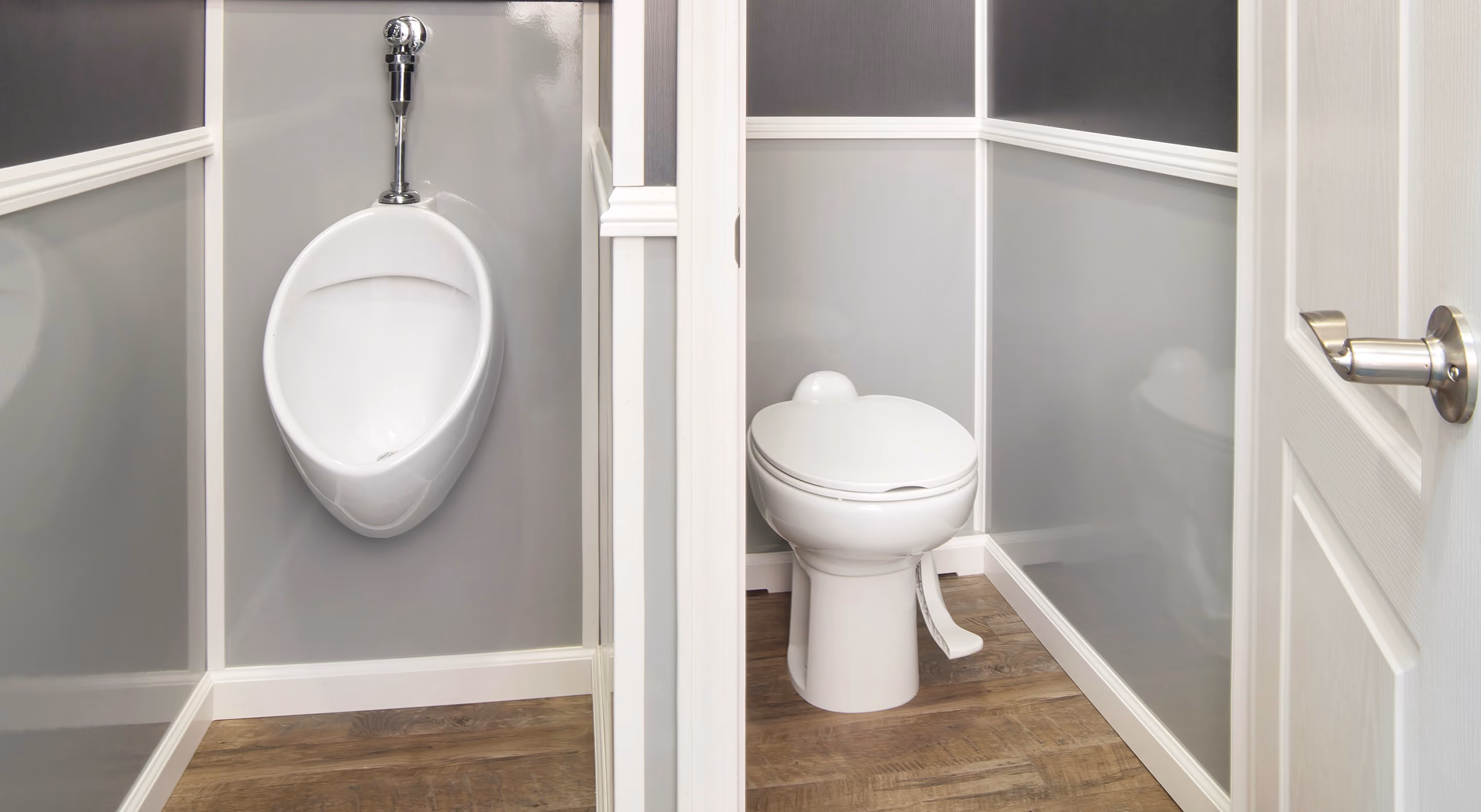 A men's restroom featuring a urinal on the left and a toilet on the right, separated by partitions.
