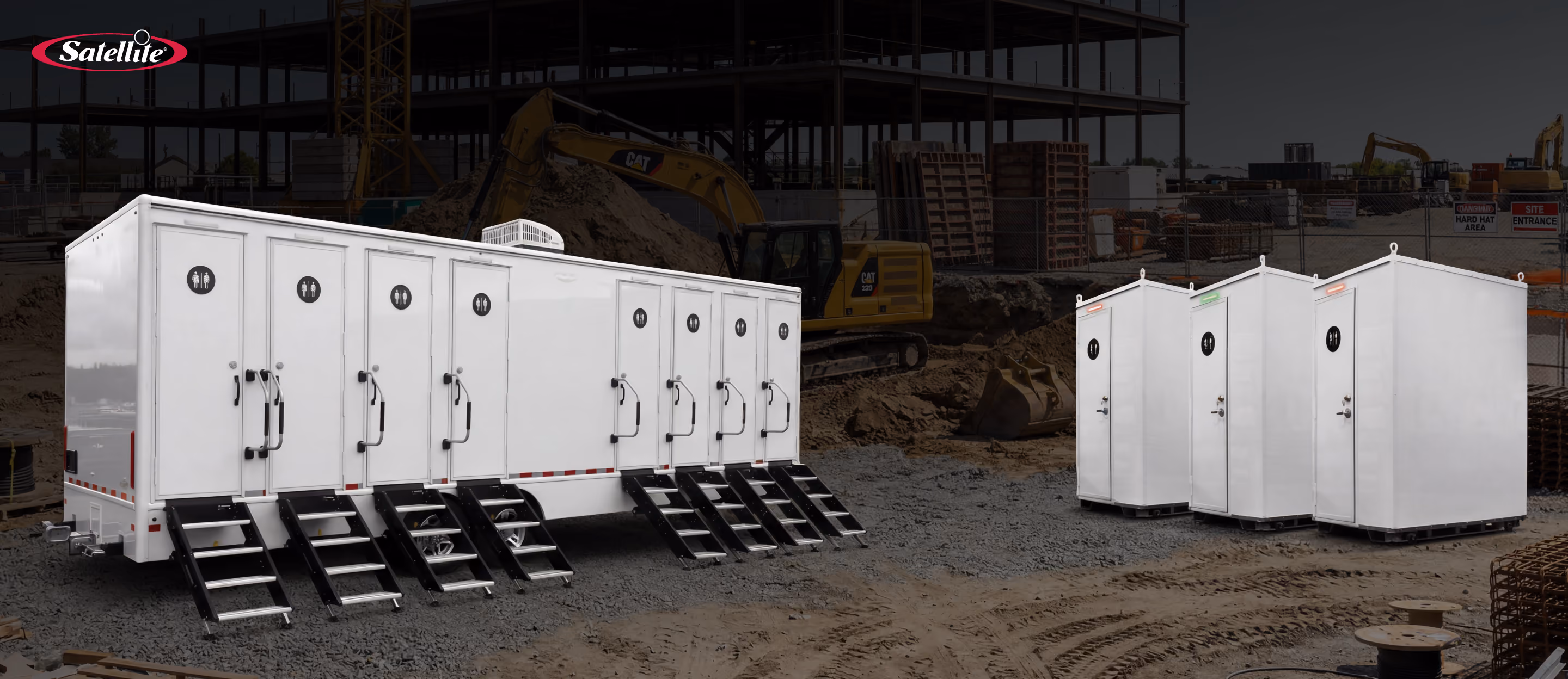 Satellite Industries portable restroom trailers and standalone brick toilet portable restroom units deployed on a large data center construction site, providing scalable sanitation solutions for construction workers. The image highlights portable sanitation equipment for data center construction, including restroom trailers, portable toilets, workforce support infrastructure, and jobsite sanitation solutions that improve productivity, compliance, and worker satisfaction.