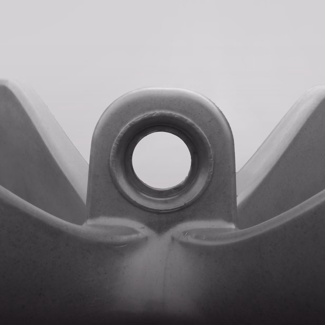 Integrated lifting eye viewed from the front, featuring a circular hole and tapered edges.
