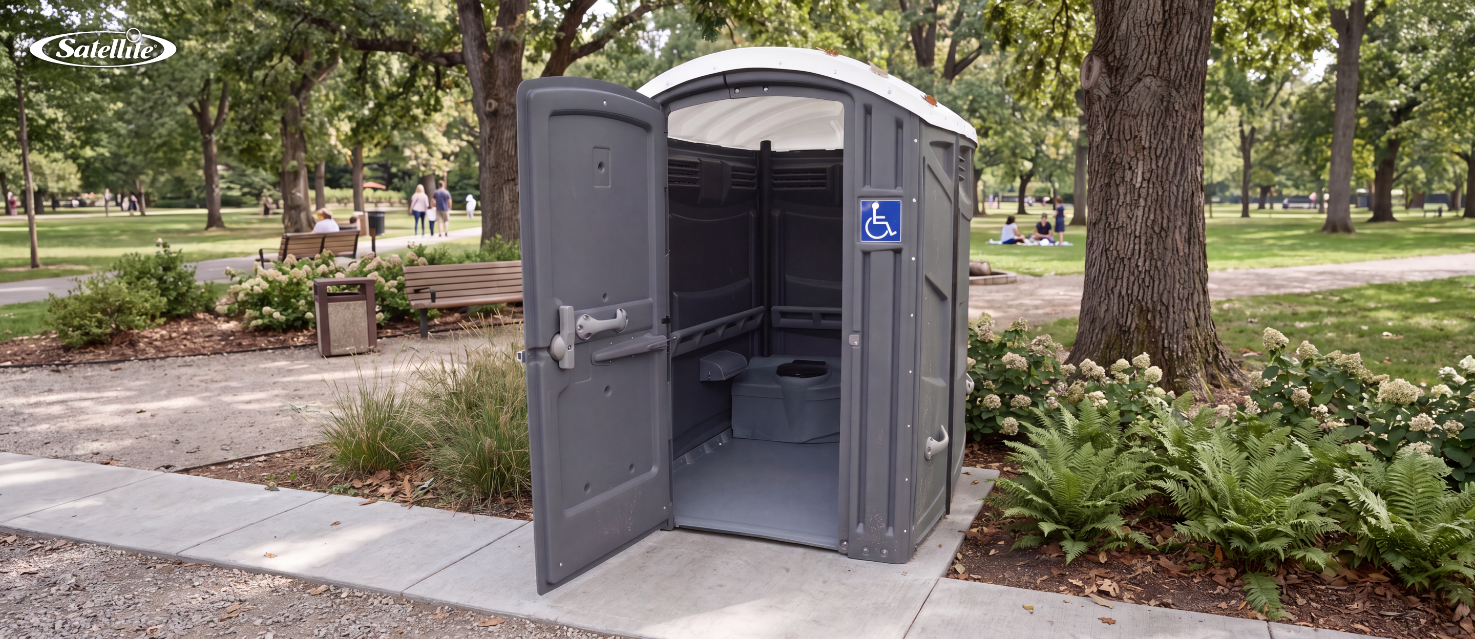 ADA-compliant portable restroom installed in a public park with an accessible entrance, spacious interior, grab bars, and wheelchair accessibility features. This ADA portable restroom demonstrates inclusive portable sanitation designed for parks, outdoor events, construction sites, and public spaces, ensuring accessibility, safety, and compliance with Americans with Disabilities Act (ADA) standards.