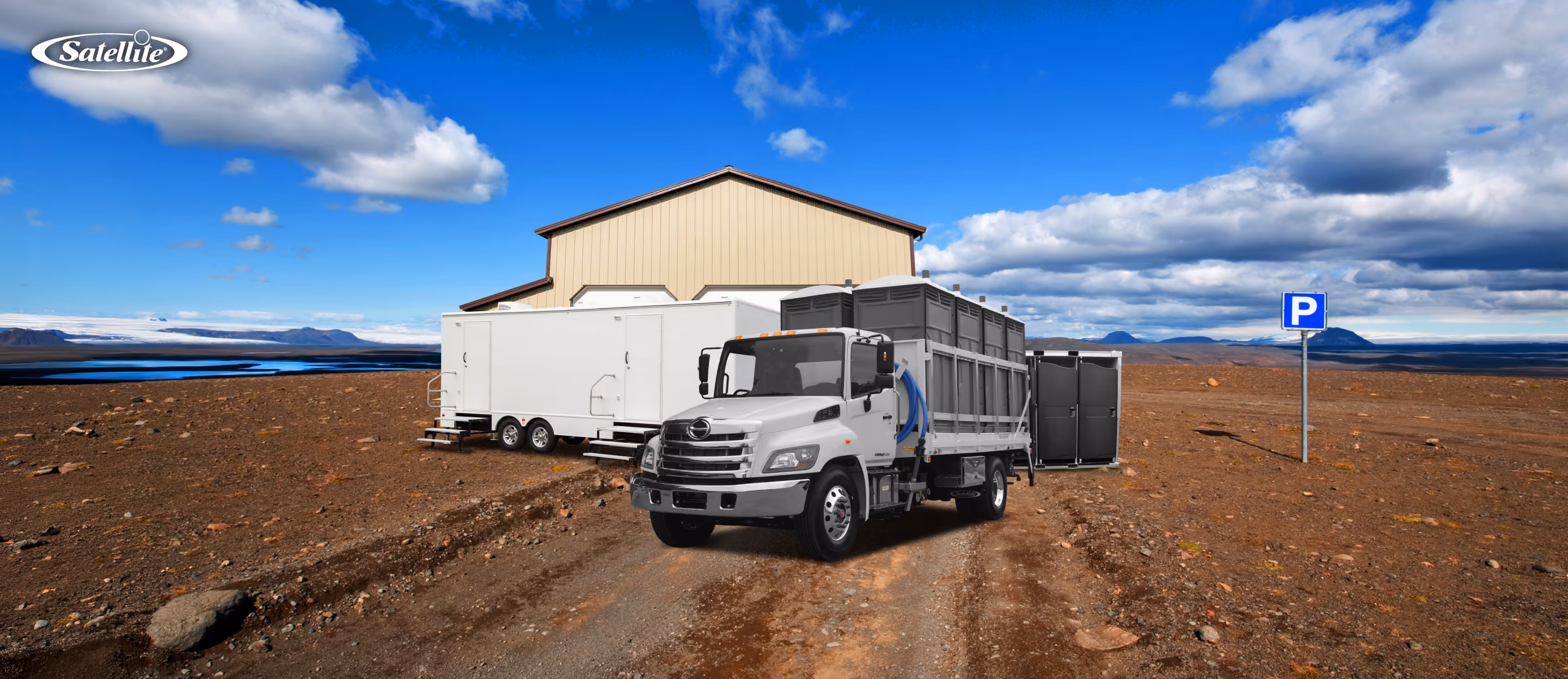 Satellite Industries portable sanitation equipment, including restroom trailers, portable restrooms, and a service truck, staged at a remote project site. The image represents portable sanitation business opportunities in construction, mining, industrial operations, disaster response, outdoor events, and emerging global markets.