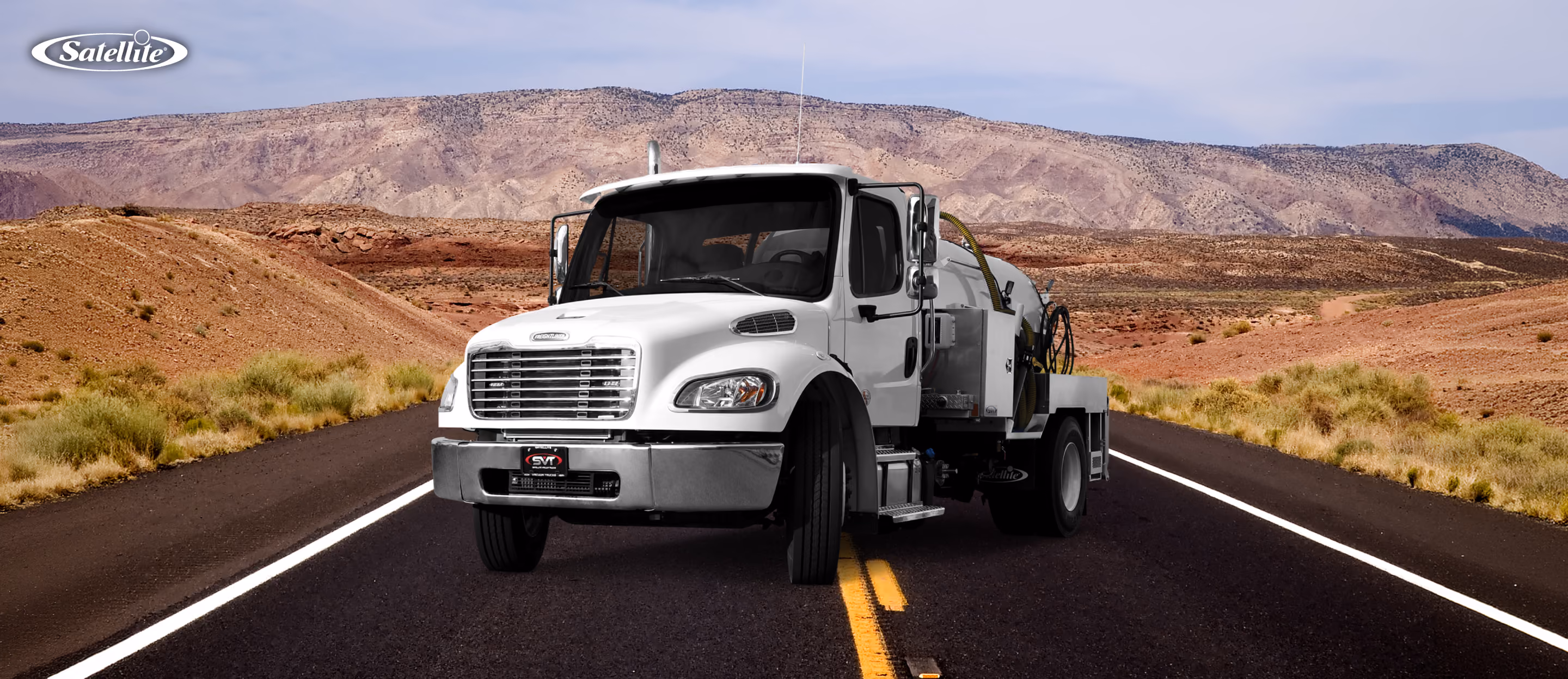 Satellite Industries portable restroom service truck driving on a highway, representing efficient route planning, fleet management, portable restroom servicing, driver productivity, fuel efficiency, and optimized service routes for portable sanitation businesses.