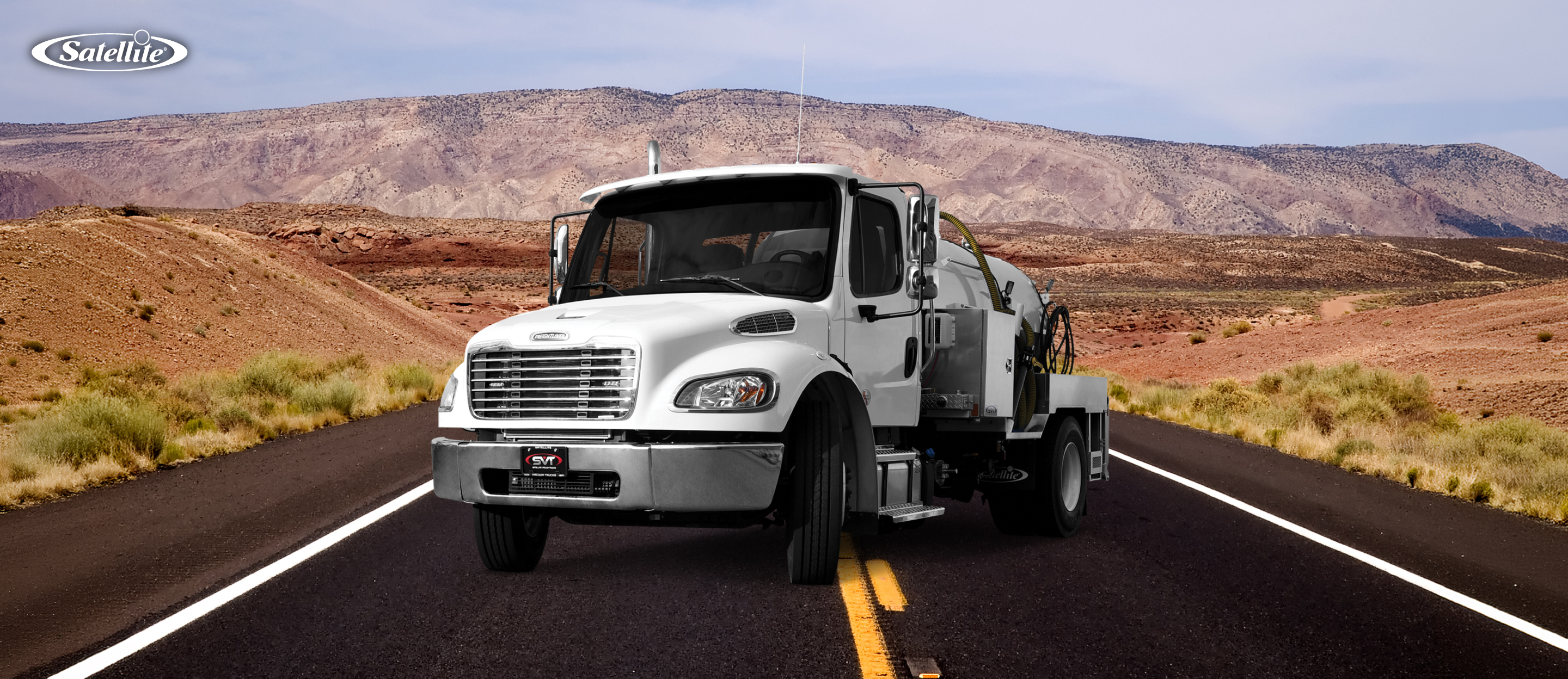 Satellite Industries portable restroom service truck driving on a highway, representing efficient route planning, fleet management, portable restroom servicing, driver productivity, fuel efficiency, and optimized service routes for portable sanitation businesses.