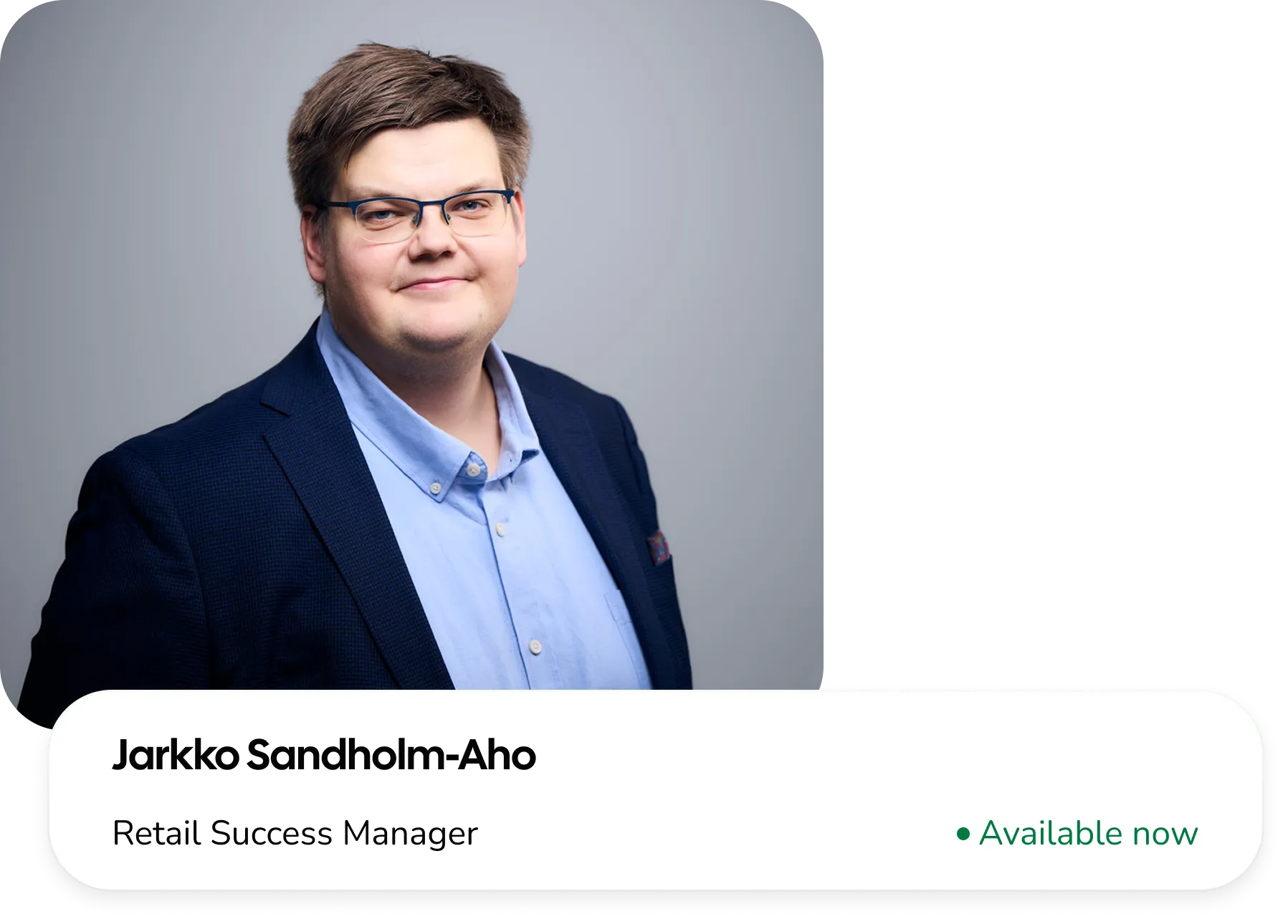 Zoomed-in photo of the left side of a white carved pumpkin revealing its triangular eyes and toothy smile on a dark background.