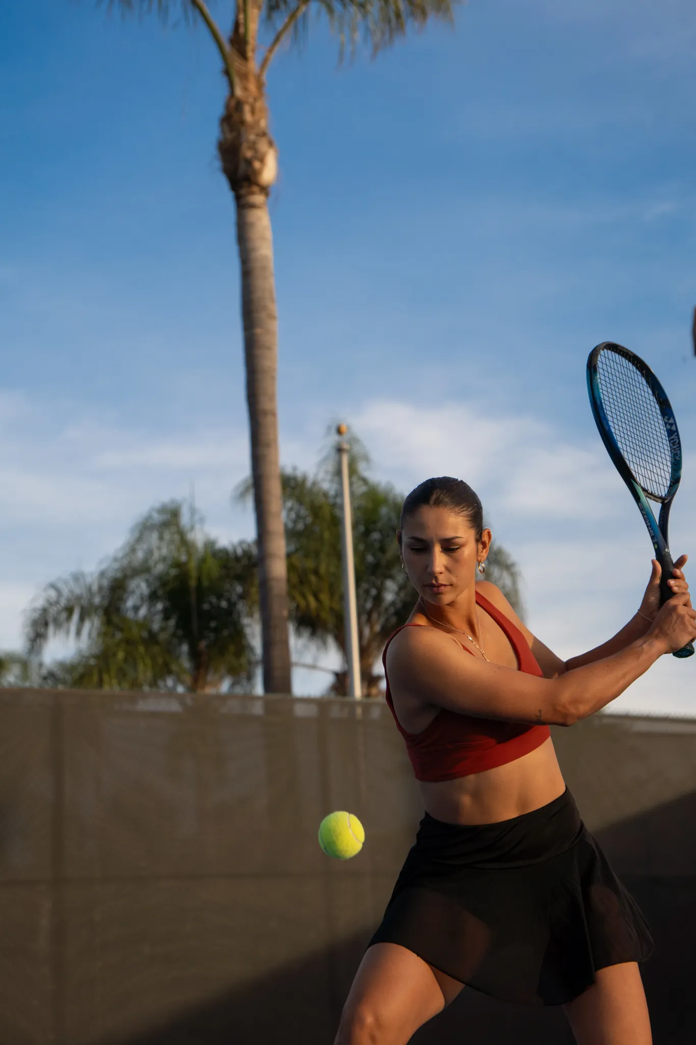 A girl playing tennis.