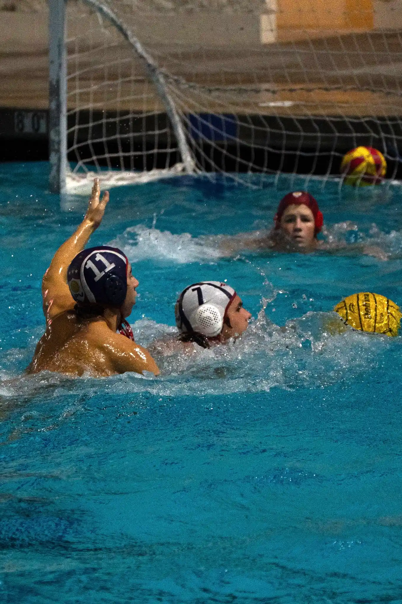 Two boys playing water polo.