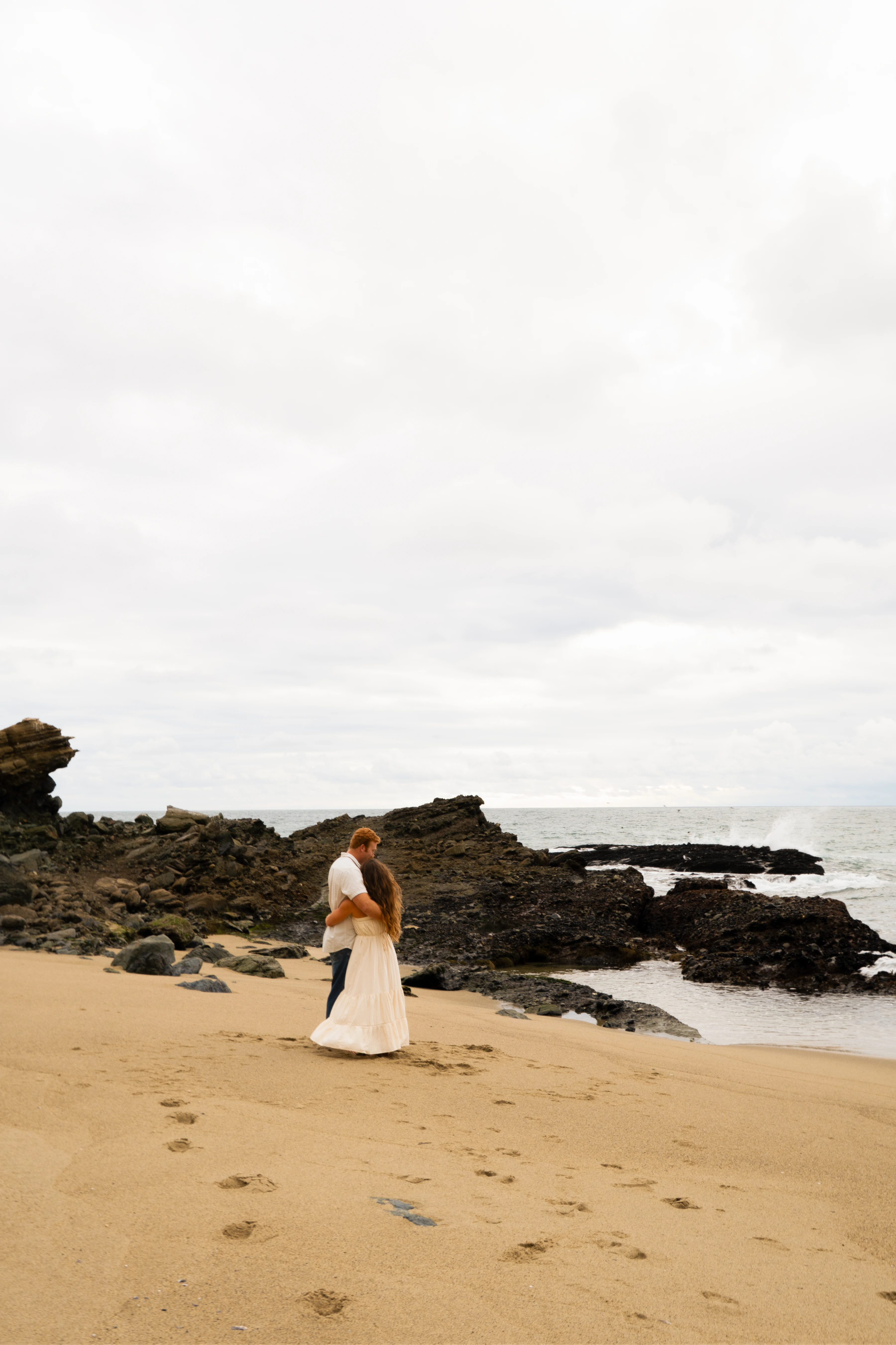 A couple running along the beach together.