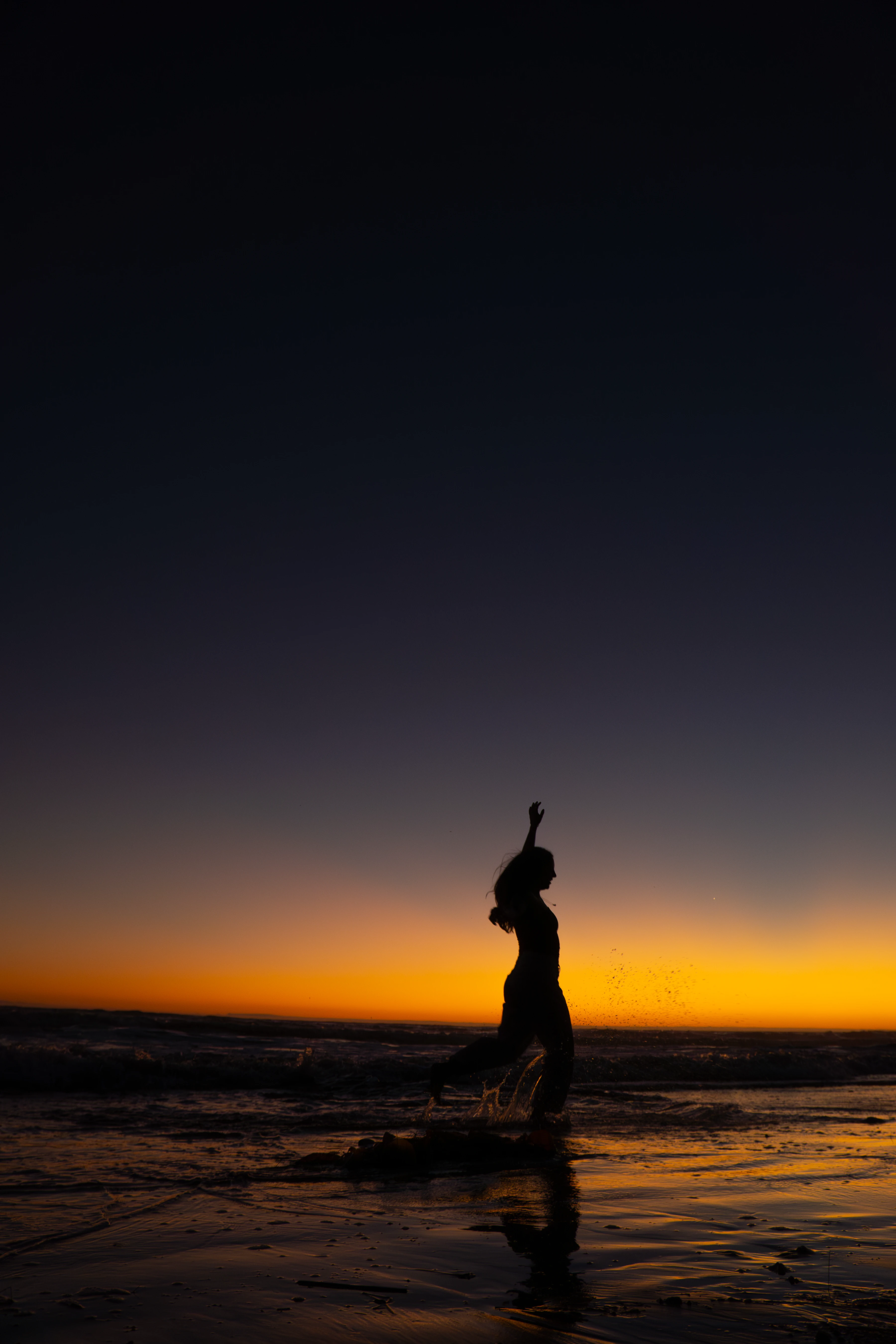 An athlete running on the beach boardwalk, wearing green shorts and a white bra, with cute braids and sunglasses.
