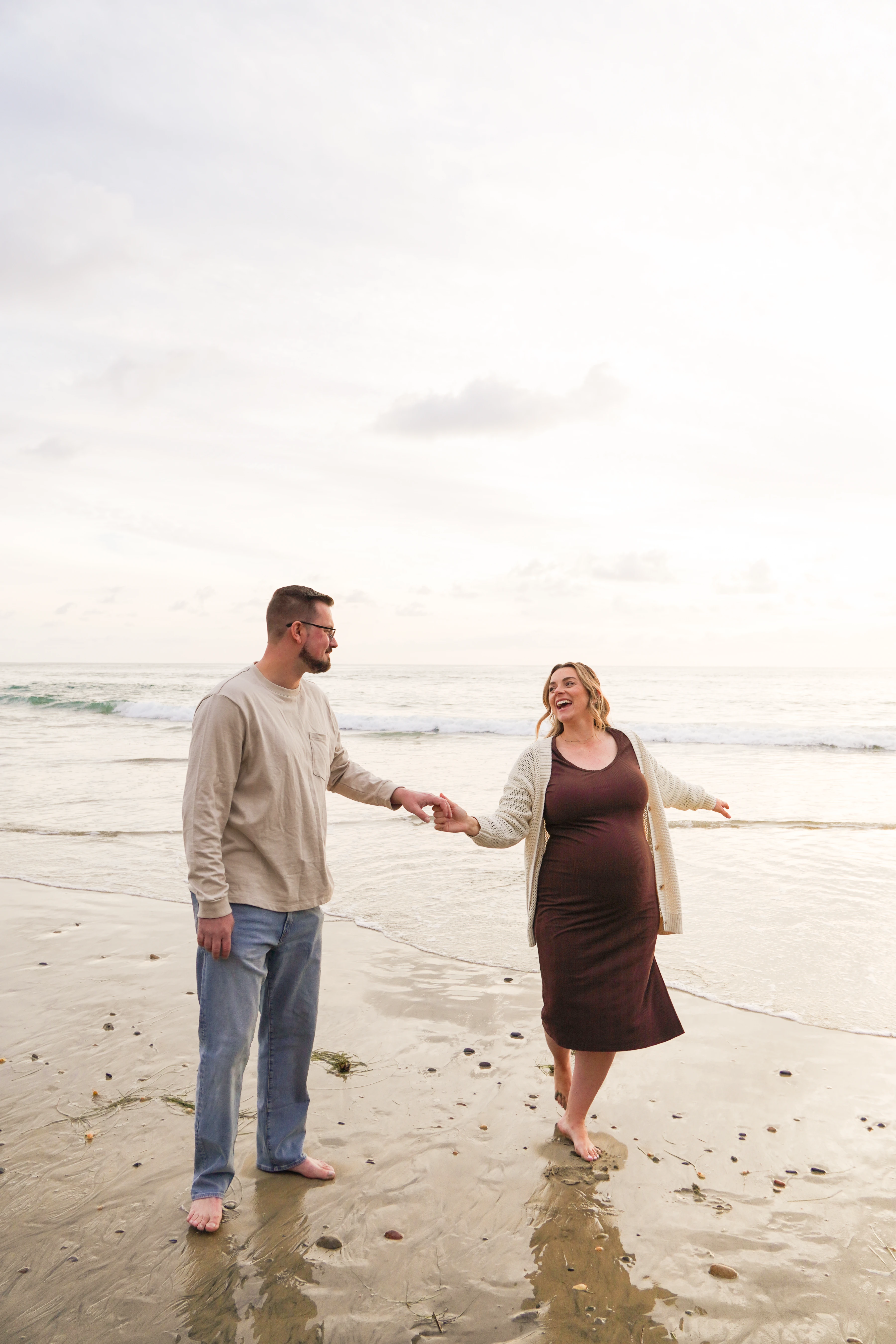 A cute couple, dancing on the beach.