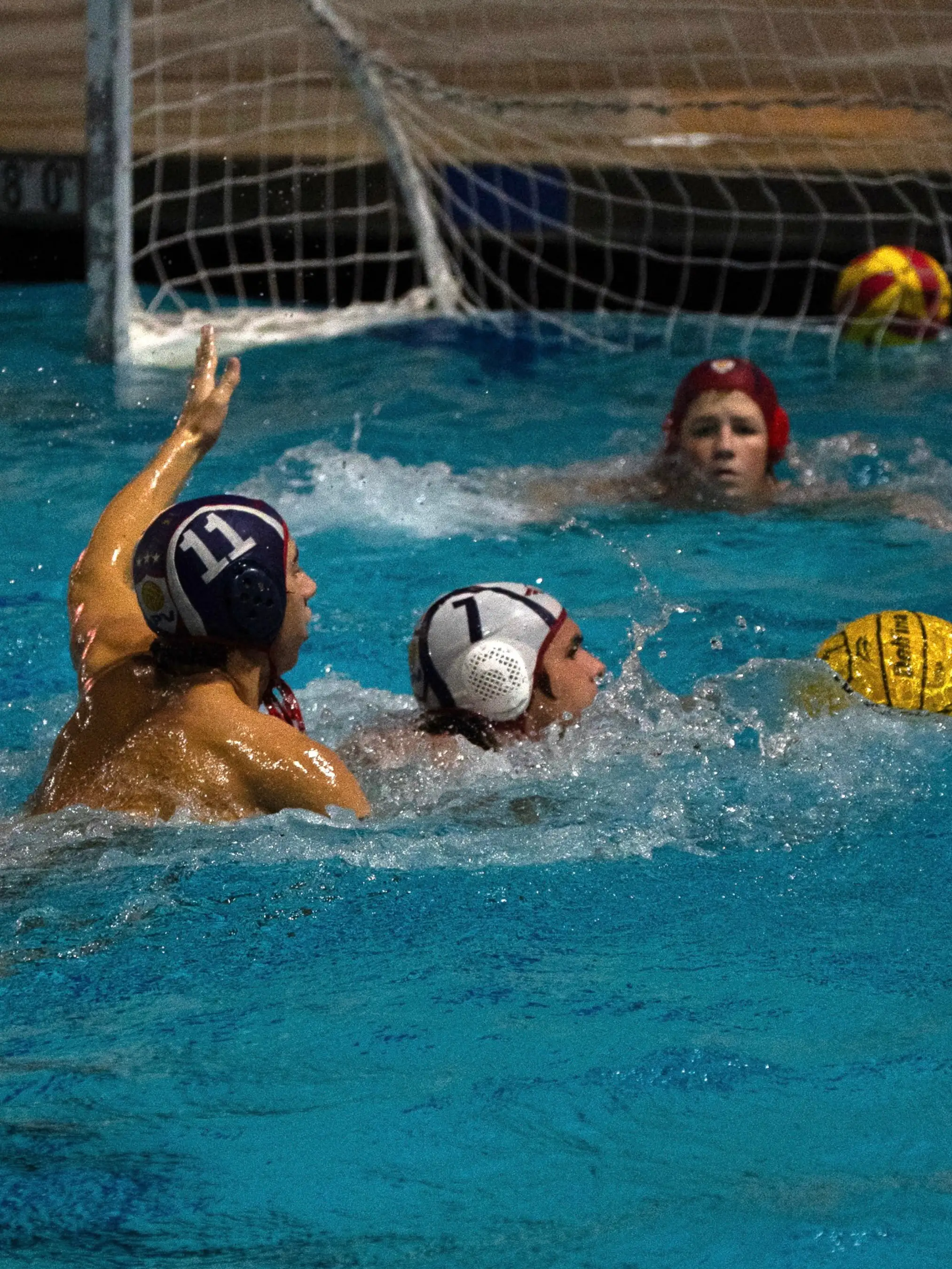 Two water polo athletes playing each other.