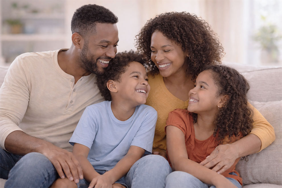 Therapist explaining oral health and breathing using teeth model to child and parent