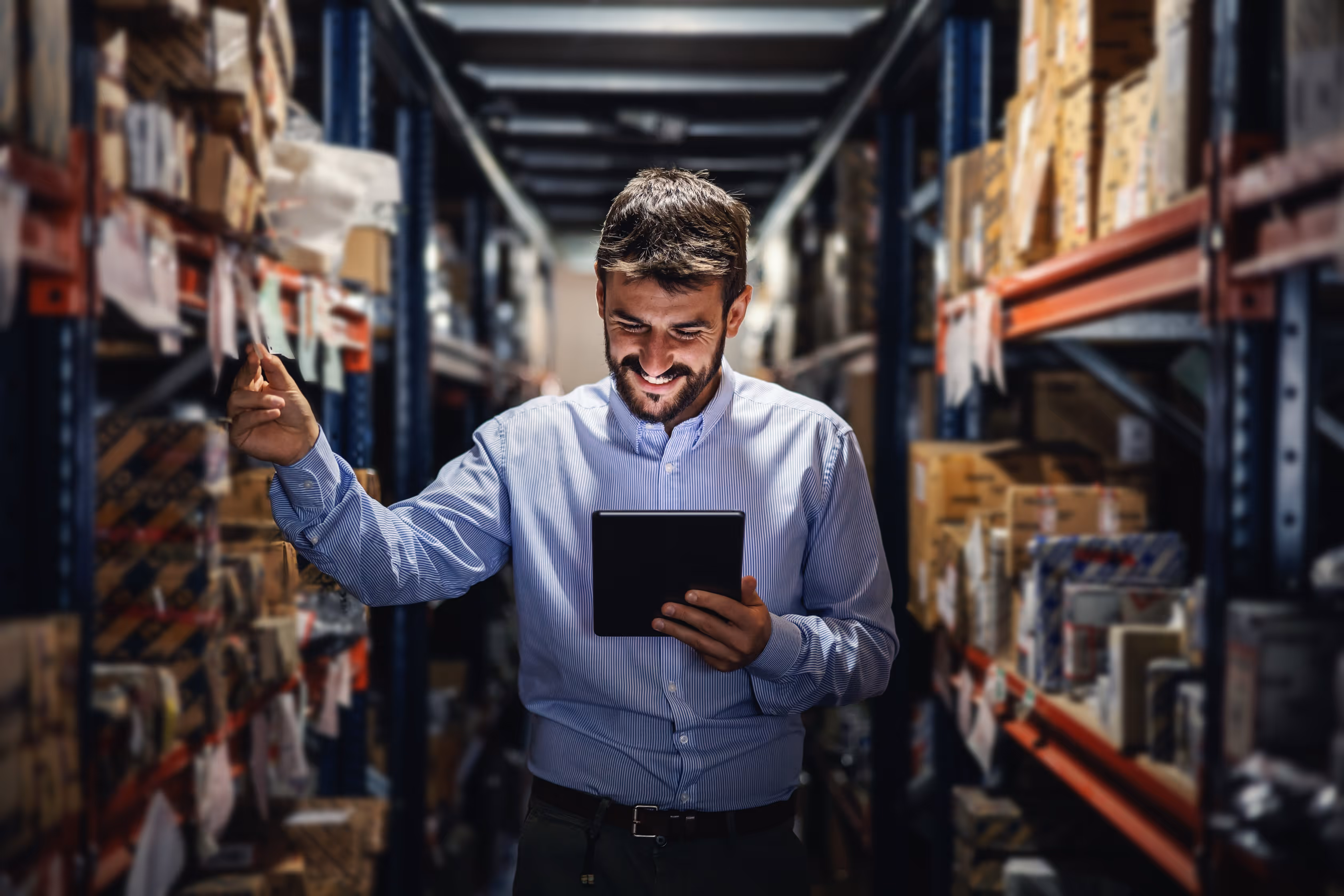 Project manager reviewing records on a tablet in an archive storage room