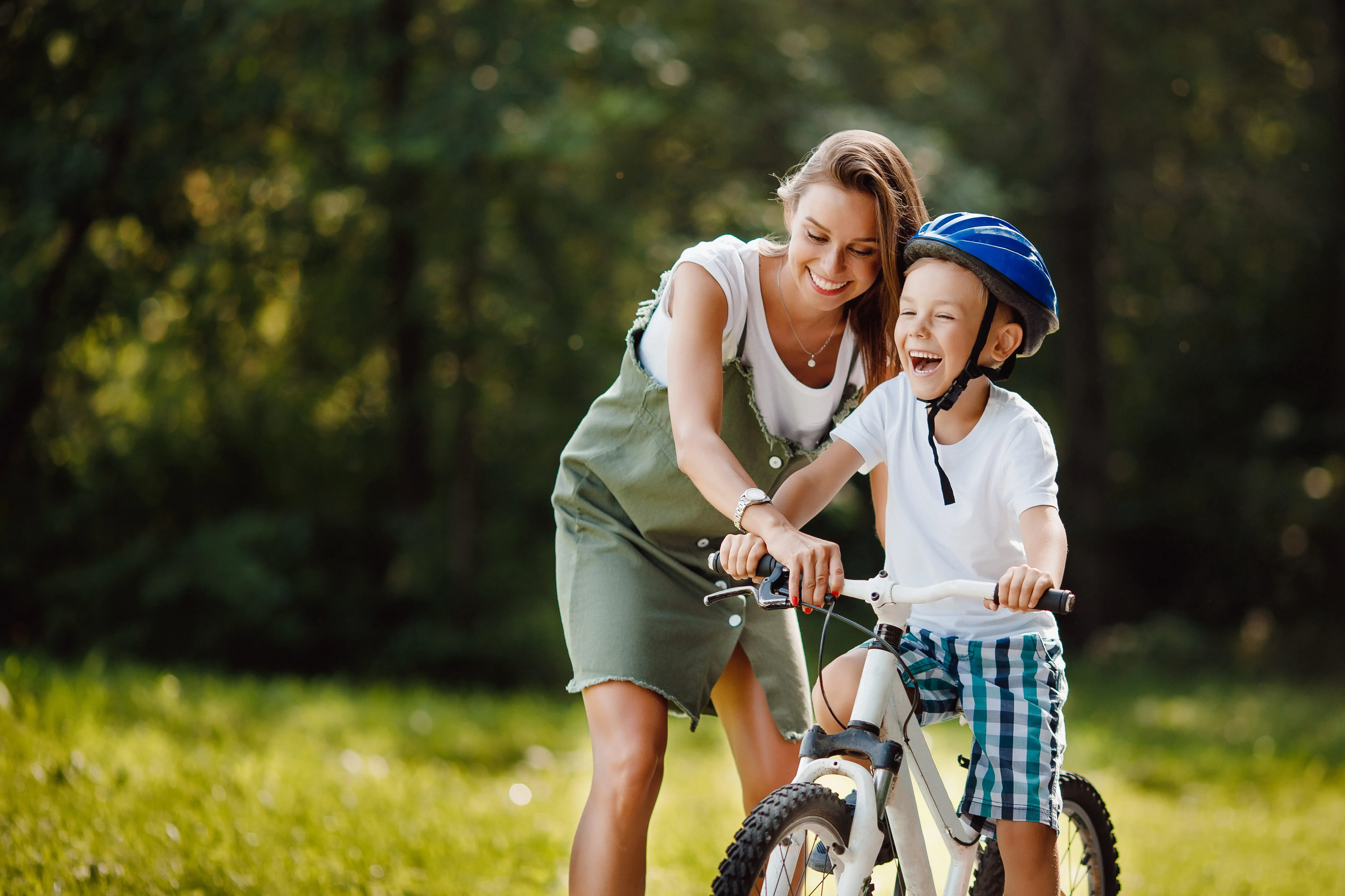 person with kid on bike stock image