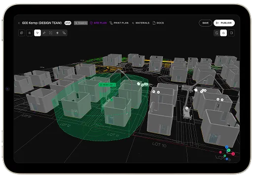 Tablet screen with 3D site plan of grey building models and a highlighted green print area