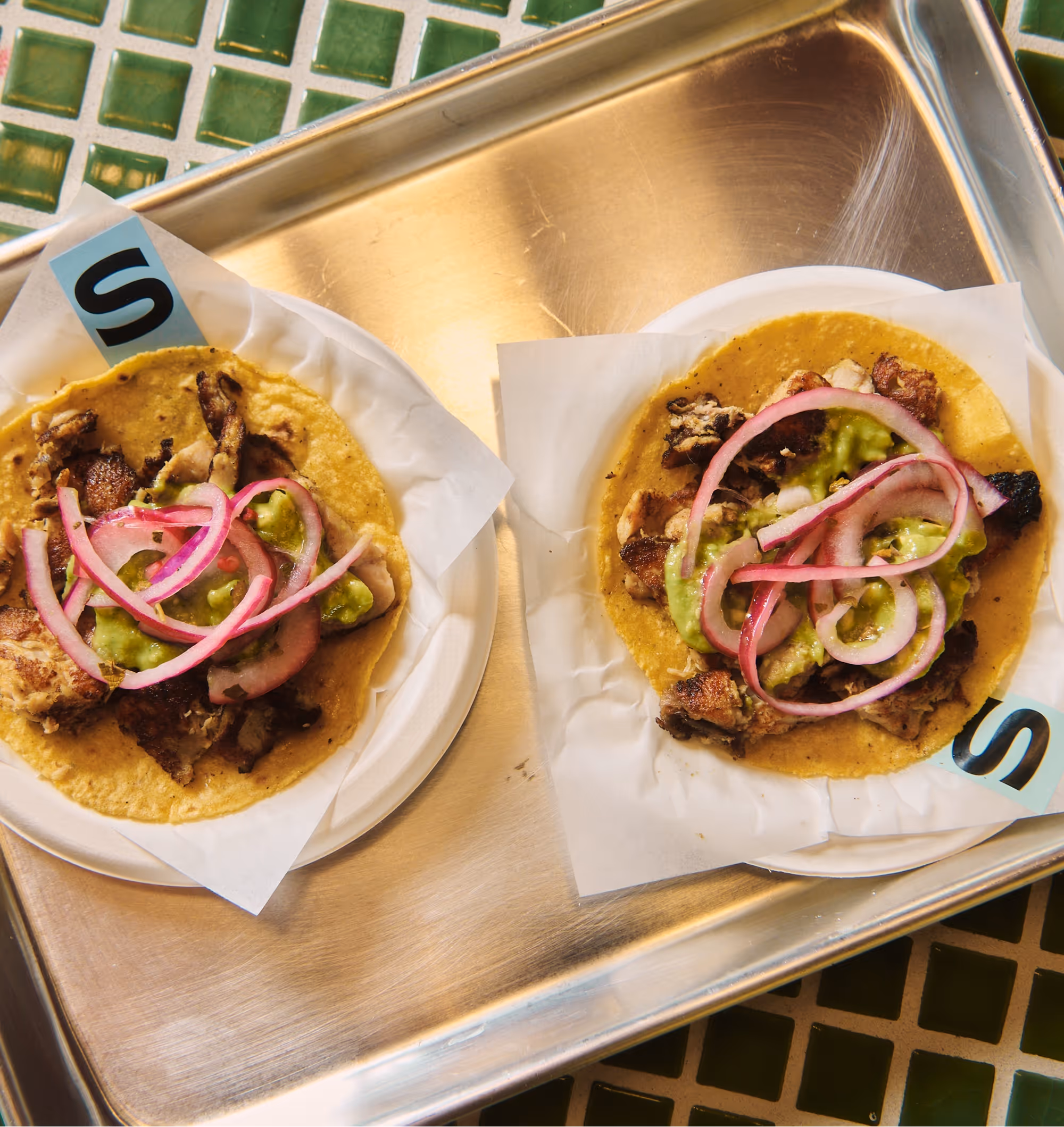 Couple of The Chicken Tacos on a silver tray