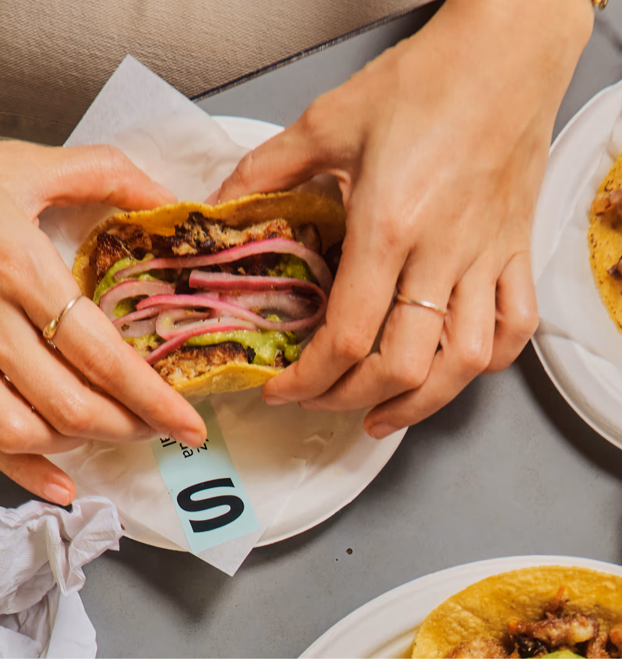 Woman holding The Chicken Taco
