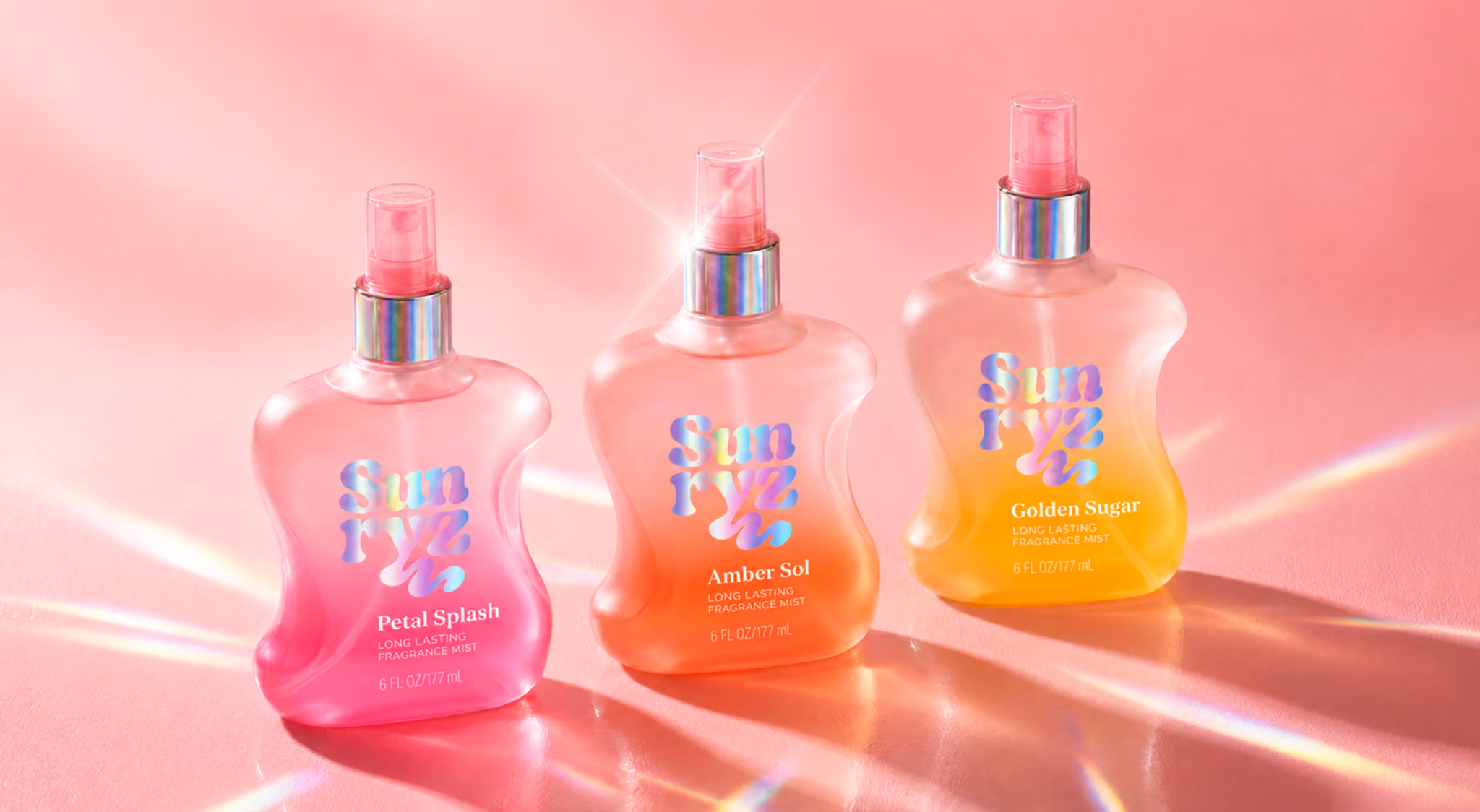 Tablet showing digital designs of three Sunryz fragrance mist bottles surrounded by real skincare products and colorful sketches on a white table.