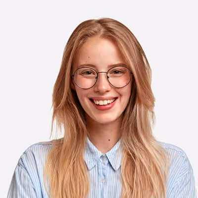 Smiling young woman with long blonde hair wearing round glasses and a light blue striped shirt.