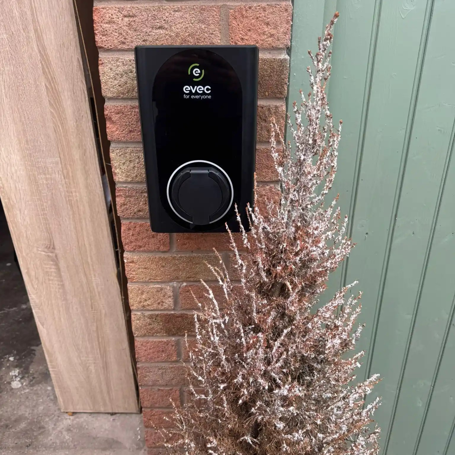 EVEC VEC01 home EV charger installed on a garage pillar