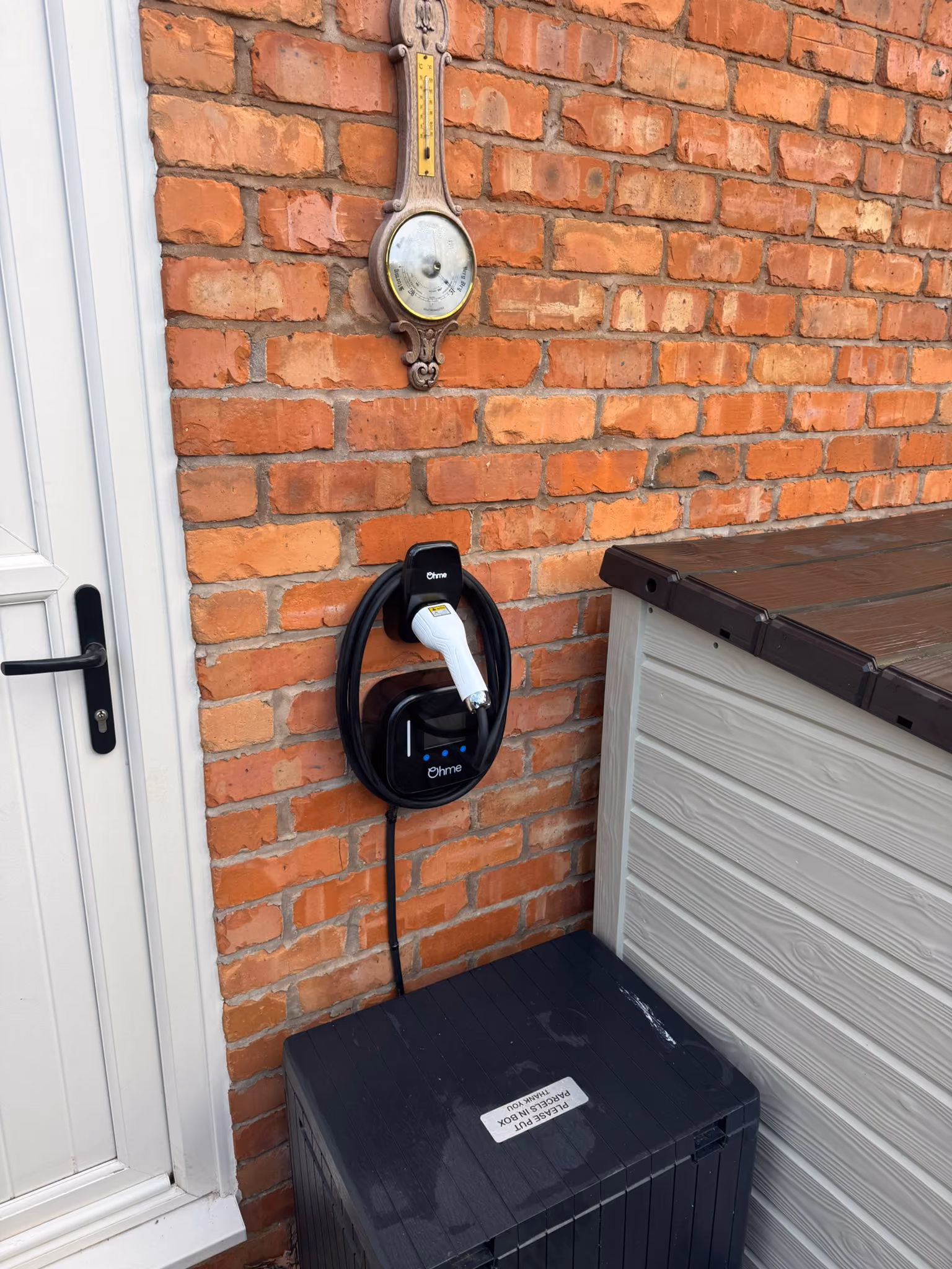 ohm ev charger installation on house near door
