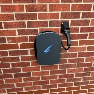 Installed Hypervolt home EV charger on a brick wall