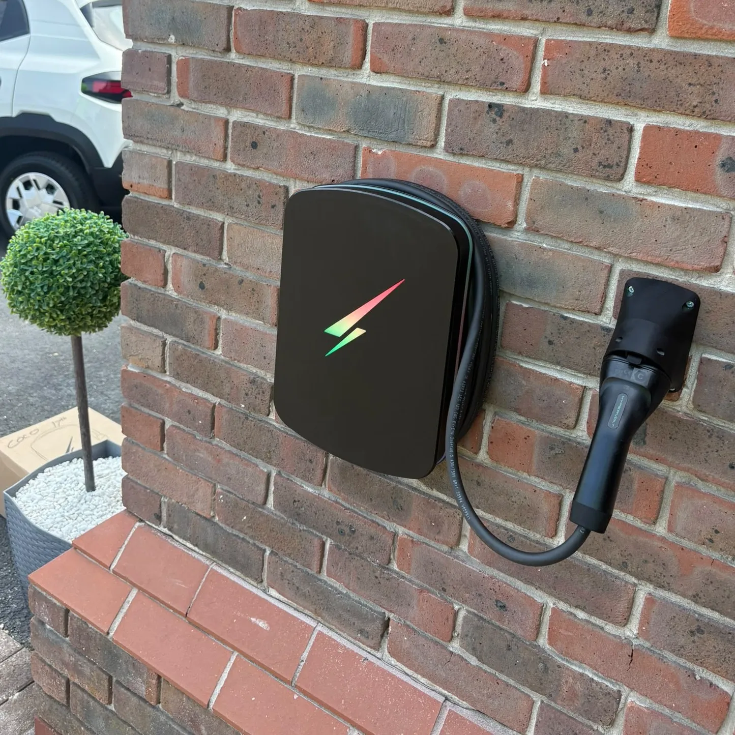 ohme home ev charger installed under light
