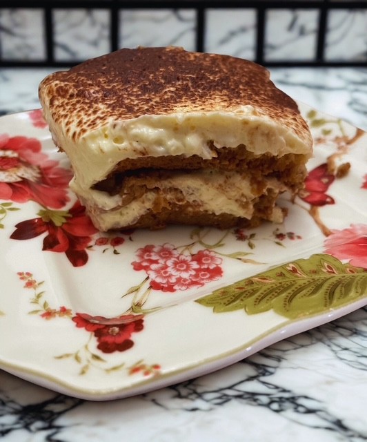 Burger with fried fries on black plate with sauce on the side