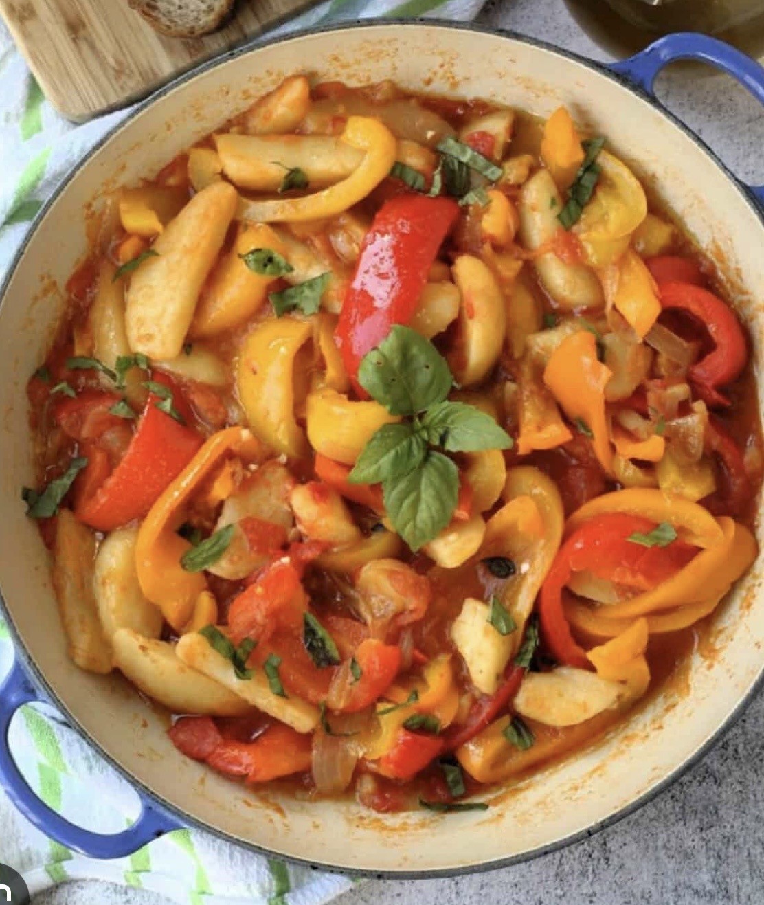 Burger with fried fries on black plate with sauce on the side