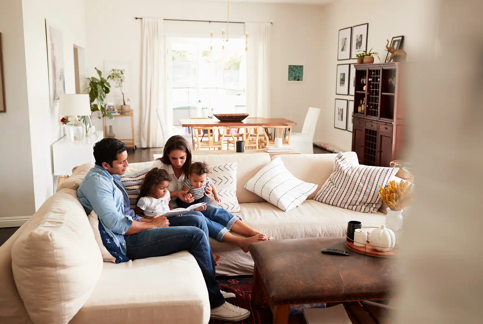 Parents and children sitting on the couch reading together