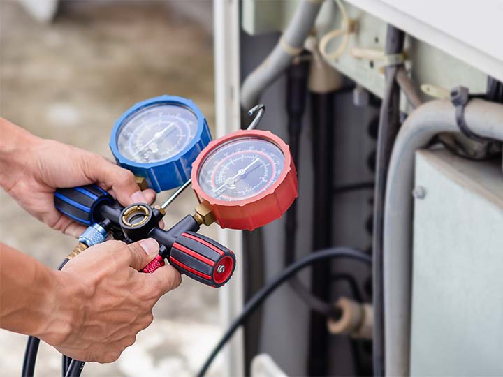 A view of HVAC testing equipment held by a technician