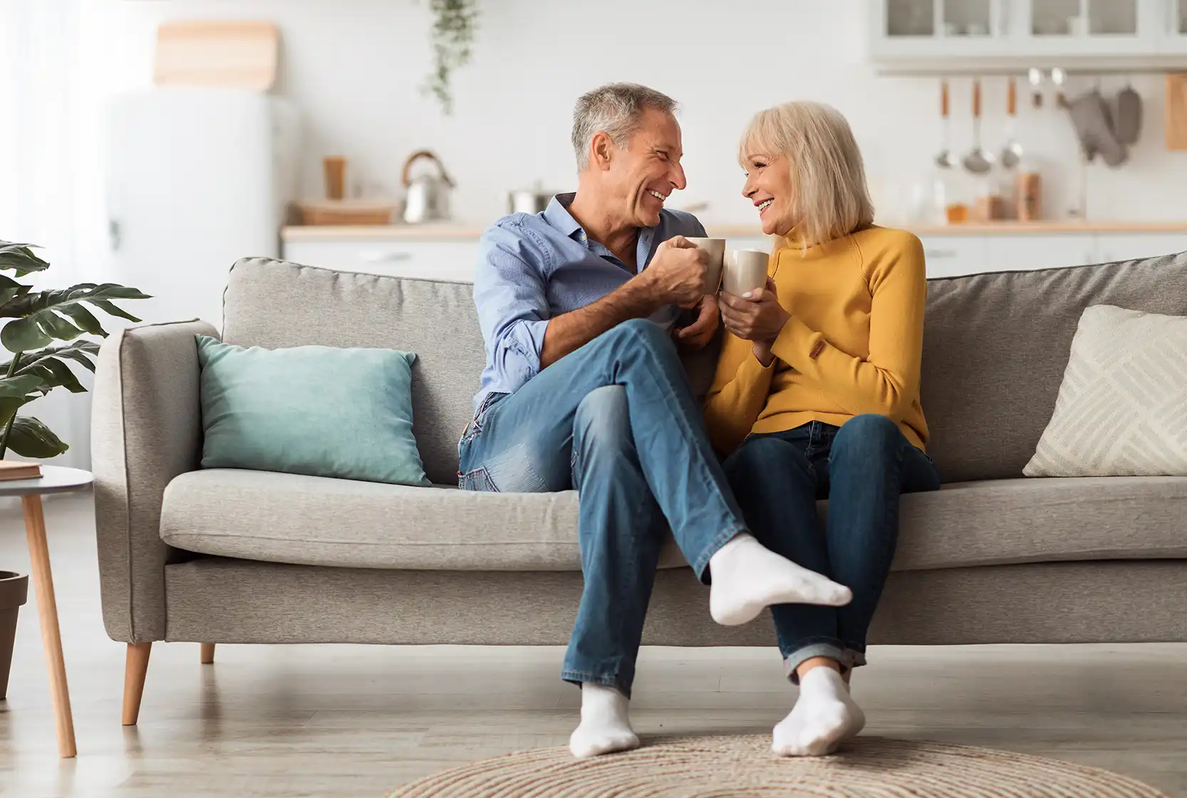 A couple sitting on a couch in their living room