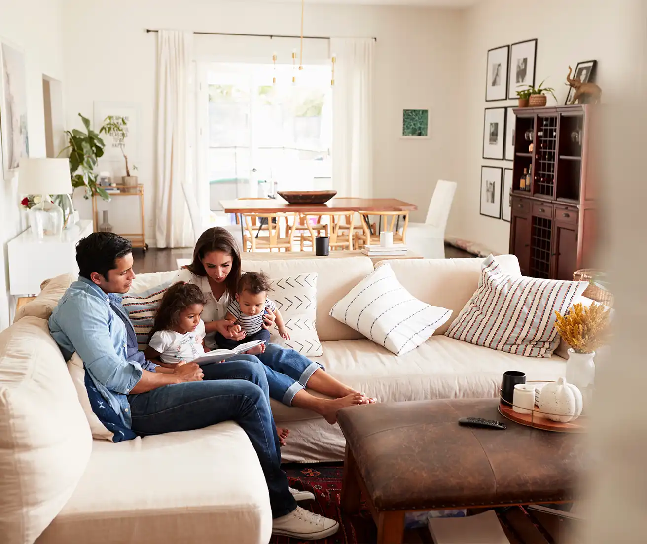 A family sitting on the couch ready together and enjoying their clean air quality