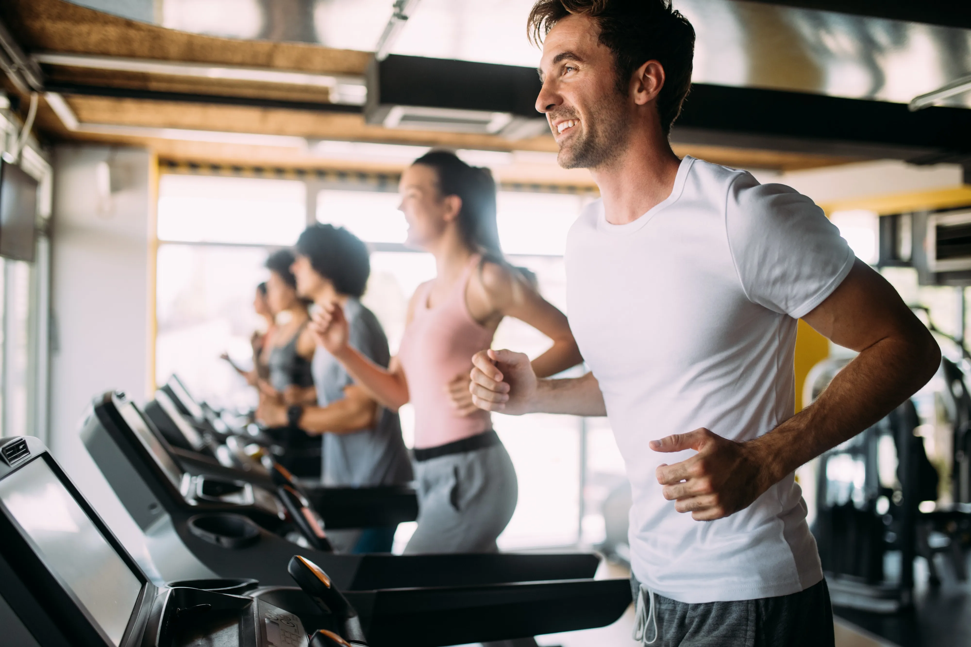people running on treadmill stock image