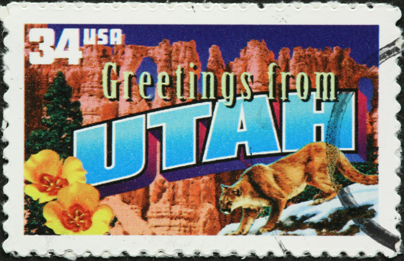 "Greetings from Utah" vintage-style postage stamp featuring a cougar and desert landscape.