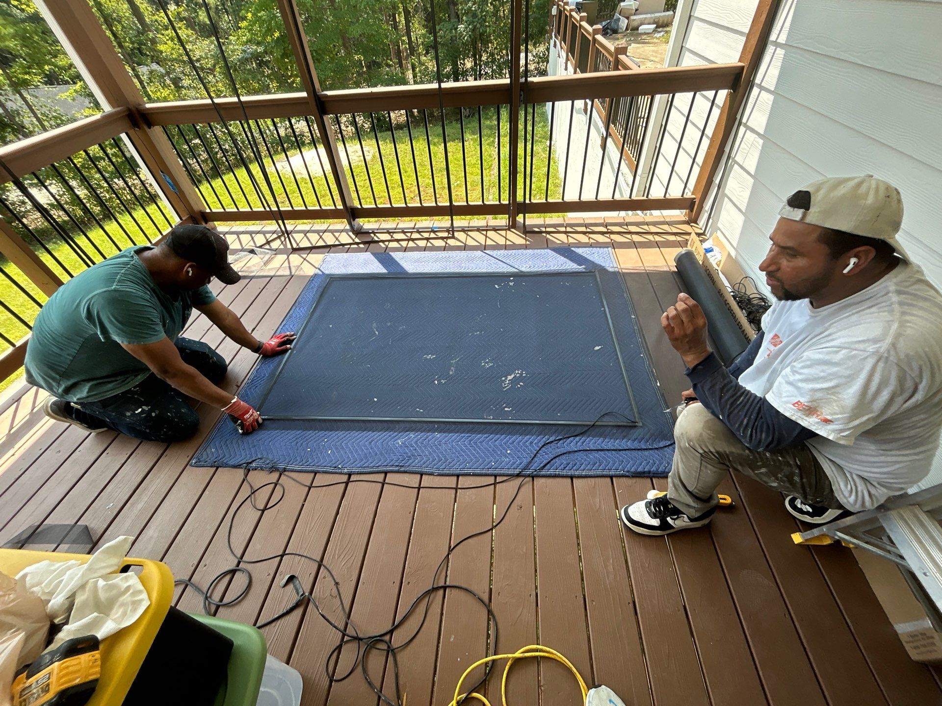 RenoMaxing — crew installing porch screens at 148 Pope Paul Path