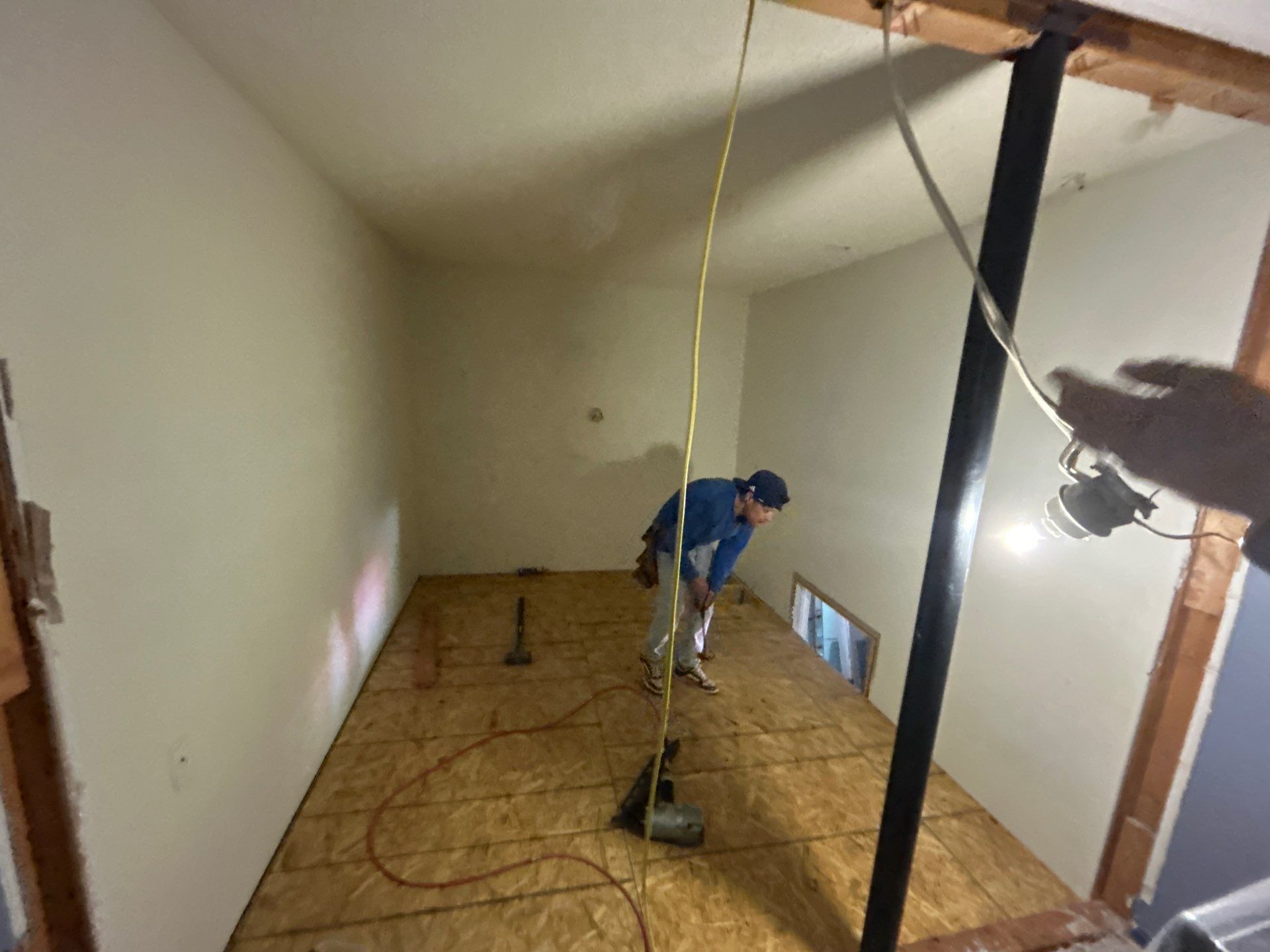 RenoMaxing — worker repairing the subfloor